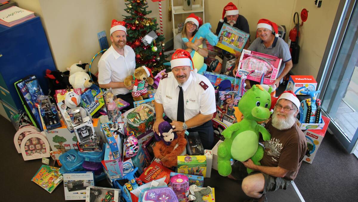 Preparing to distribute presents collected in the BDN Christmas Toy Drive are BDN editor Ben Smyth, Salvation Army lieutenant Rod Parsons, Anglicare's Vesna Andric, BDN sales rep Gary Etcell, Bega Lions president Phil Benny and Salvos helper Laurie Brett.