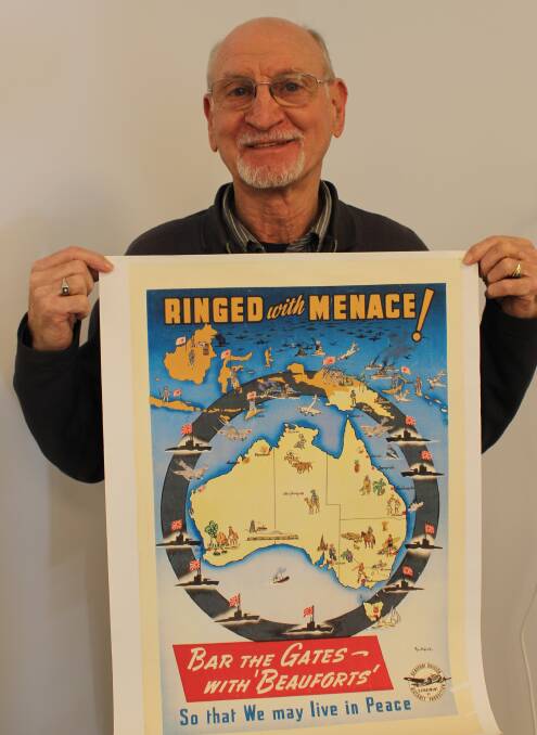 Director, Bruce Waddell holds a replica of a war-time poster.