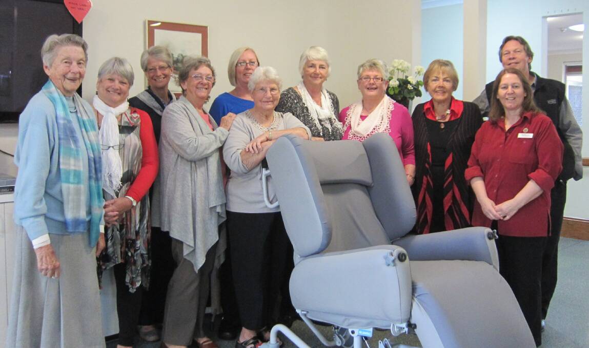 Imlay House Ladies Auxiliary members and Imlay House management with one of the new resident air chairs.