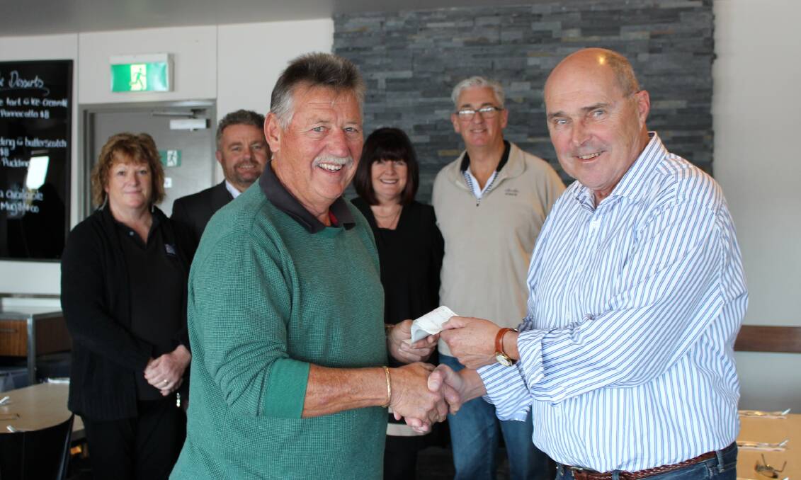 Pay day: Merimbula Tourism board member, Mike McGuire receives a cheque for $20,100 from Dennis Souter, owner of the Lakeview Hotel, Merimbula. In the background are Lesley Mutsch, Lakeview Hotel, Kevin Philistin, president of Merimbula Tourism, Rhonda Campbell, who helped on the golf day with husband, Gordon Campbell, board member of Merimbula Tourism.