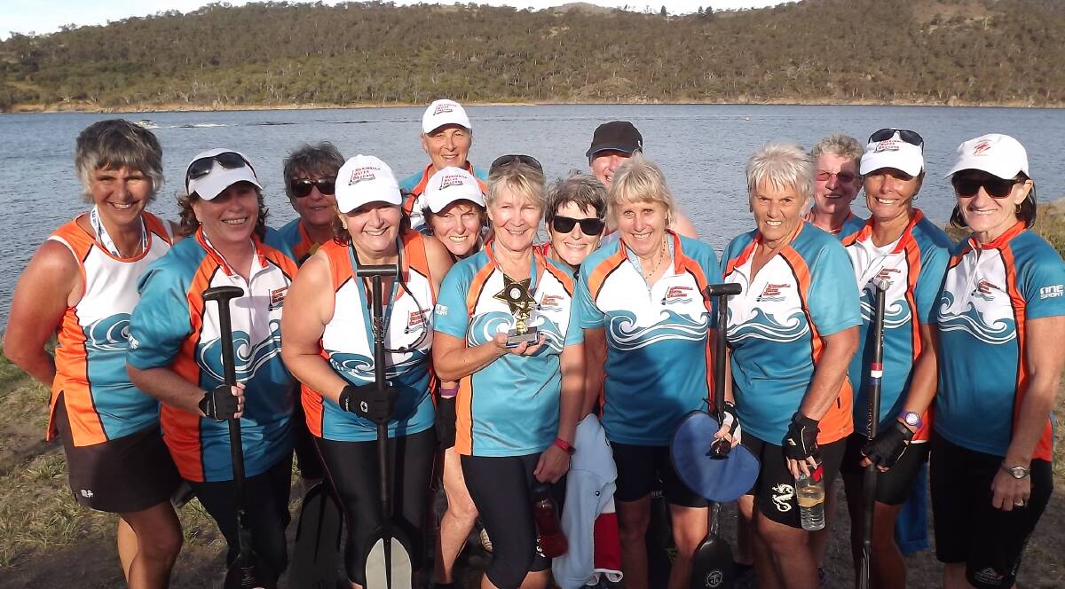 Silver stars: Sweep Sue Wakefield holds Merimbula Water Dragons trophy for second place after an exciting 2000 metre race at Jindabyne's Flowing Festival.