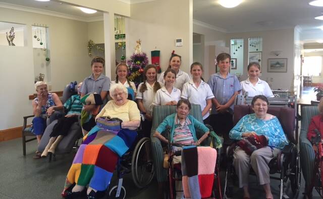 Spreading joy: Year 5s from Lumen Christi delighted Imlay House residents by delivering several knitted blankets they made by hand and singing Christmas Carols. 