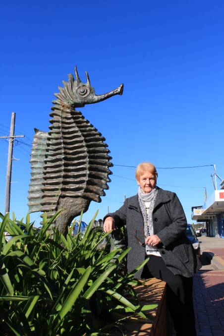 Janice Wilson with the seahorse statue by sculptor Michael Meszaros, that her father cast in his Melbourne foundry.