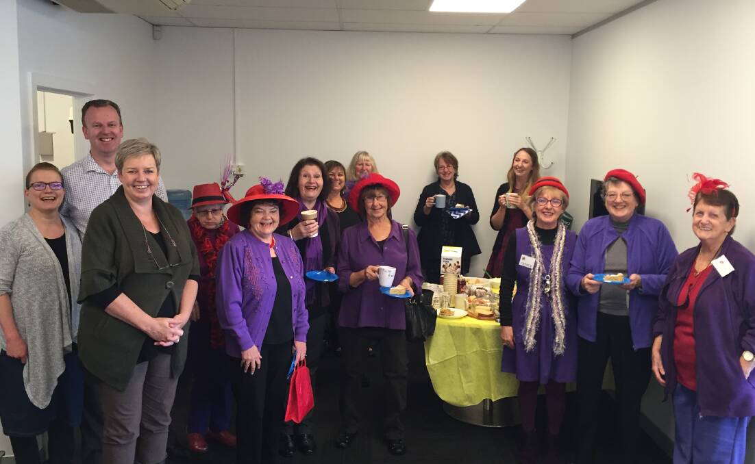 TEATIME: Local members of the Red Hat Society, visited the Merimbula News Weekly for a Biggest Morning Tea for Cancer Council NSW and helped raise $115.
