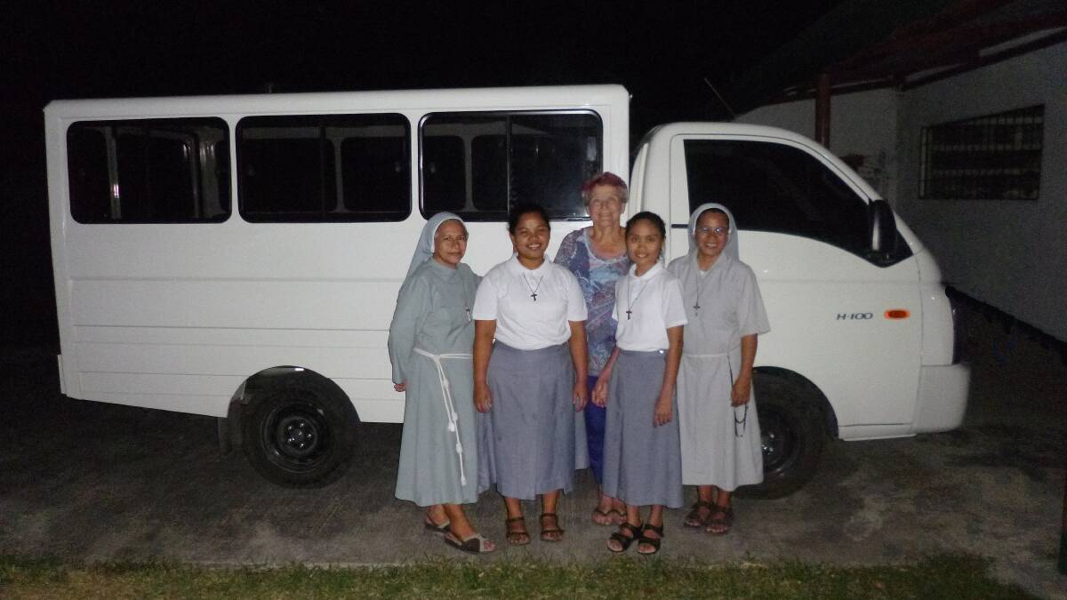 HELPING HANDS: Sister Reinalda, aspirants Joanna and Sheila and Sister Judith of Franciscan Sisters of St Anthony, Pontevedra, with Teresa Hamer, of Tura Beach and the bus that provides so much assistance for the small community.  