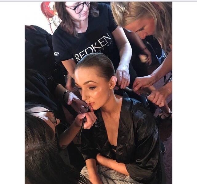 Rebecca Russell, right, works on one of the model's hair during Fashfest.