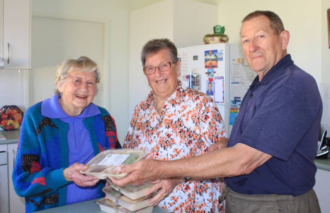 HELPING HANDS: Marjory Sullivan who was a Meals on Wheels volunteer for over 20 years now enjoys regular deliveries from volunteers Susan and Garry Stephenson.