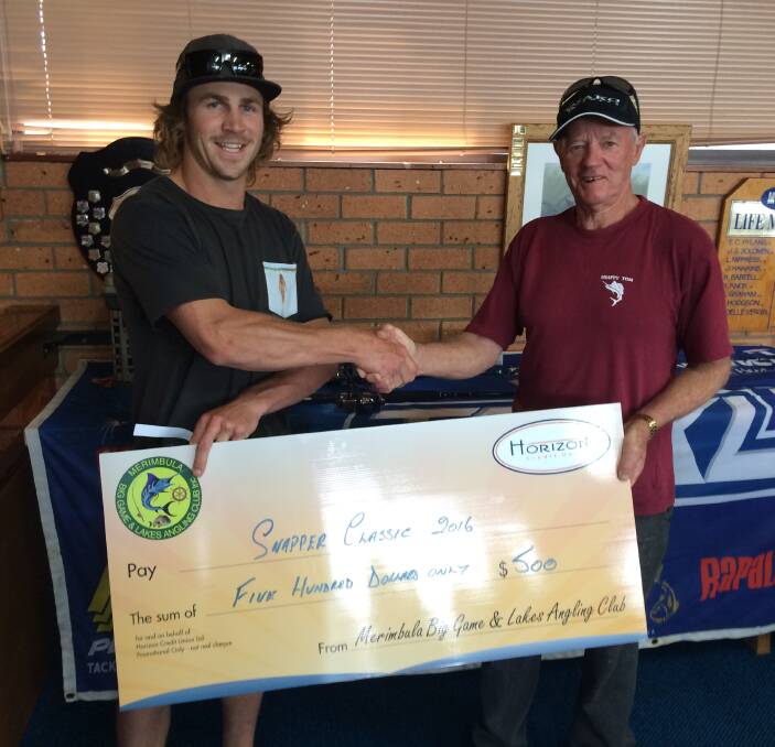 Cheque handover: Aiden Aiken Winner of the Tackle World Snapper Classic receives his first prize from Club President Robert Wood.