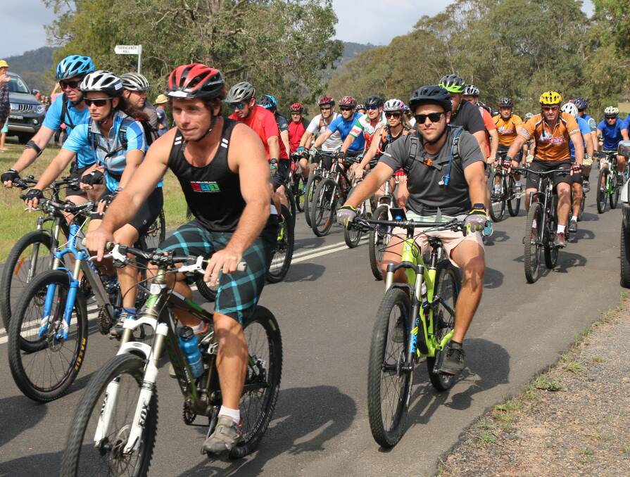 Huge entries: Riders head out from the Tarraganda fire shed for the start of the Bega to the Beach bike ride on Saturday afternoon.