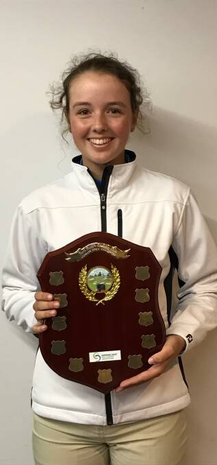 Hot shot: Tura Beach golfer Casey Cook proudly displays the junior open trophy after earlier winning the women's open trophy at the Tura Beach Country Club. 