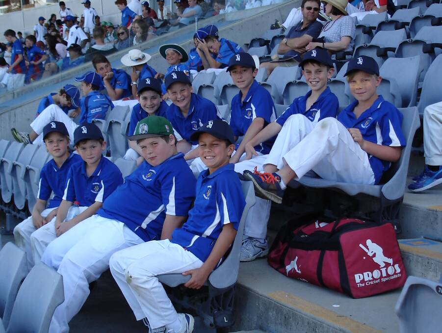 Nice view: The under 12s enjoy the view from just outside the Sir Donald Bradman stand at Manuka on Friday for the tournament presentations. 