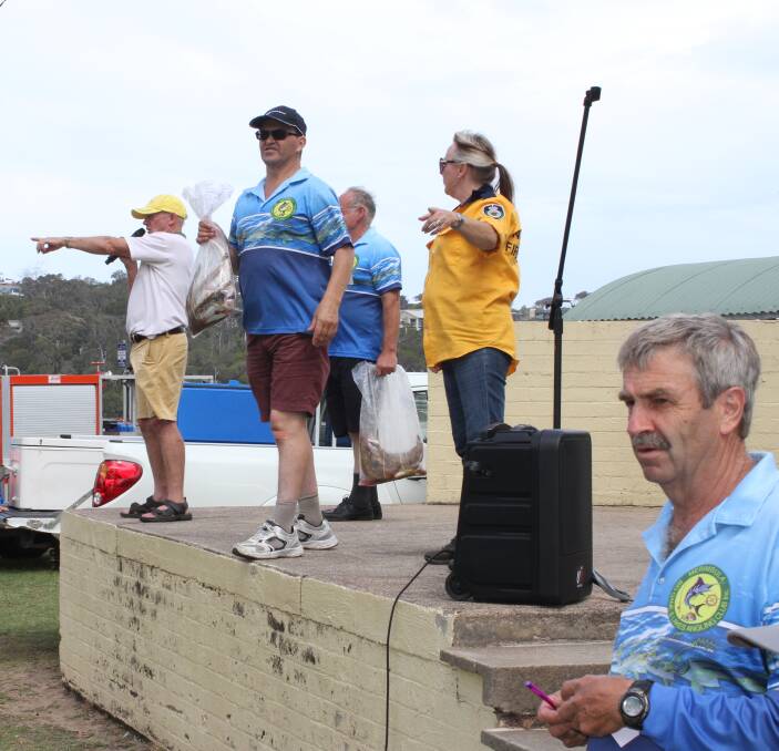 Sold!: MBGALAC officials watch for bids from the crowd during the gala fish auction last week. The auction raised $3200 which will be donated to Merimbula Volunteer Rural Fire Brigade.