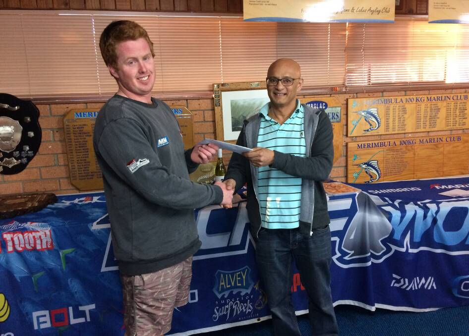 Winning team: Stuart Pentin (left) of Team 'Dripping Wet' receives $1000 on behalf of team leader Matthew Patrick from Glen Coutinho, of Caltex Merimbula.