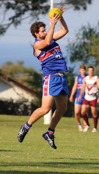 Under the ball: Daniel Worden flies high for a mark during a contest with the Bega-Tathra Sea Eagles recently as the Merimbula Diggers outdid Pambula on Saturday. 