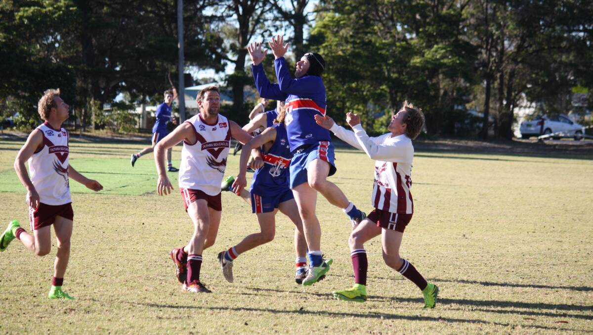 Missing out: The Diggers go up in a marking contest with the Tathra Sea Eagles during a recent round. The Merimbula club will miss finals play. 