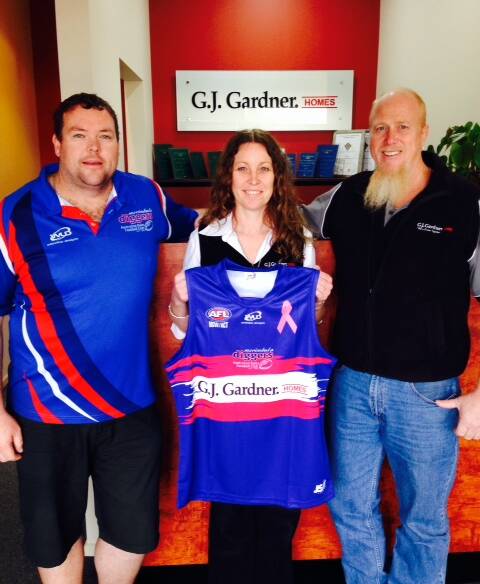 Diggers coach Ian Radford presents the special pink jersey for this weekend's local derby fundraiser with GJ Gardner owners Rose and John Smith.