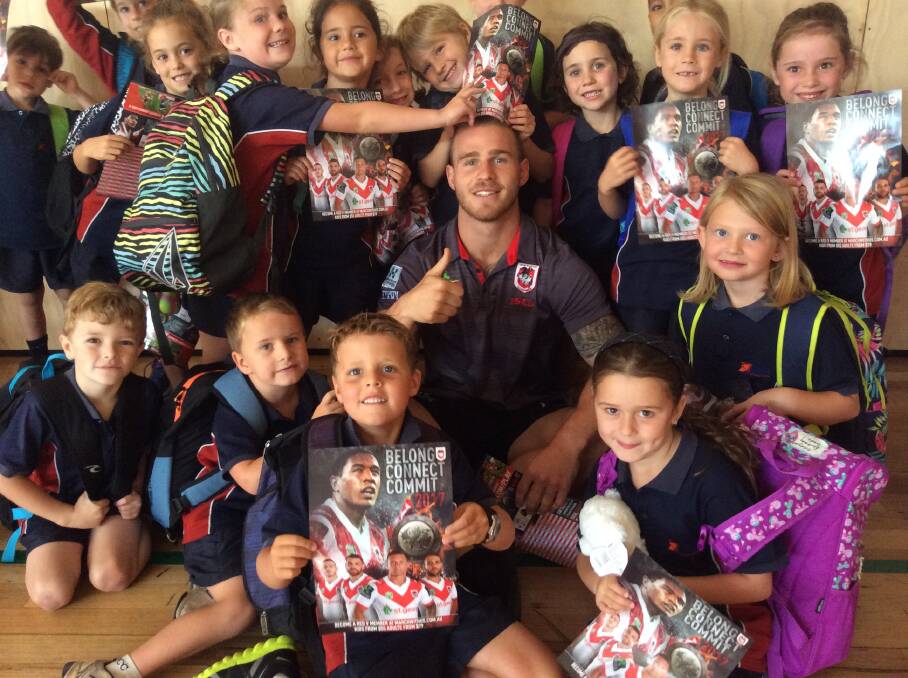 Lots of love: Lumen Christi Students show their excitement at catching up with Dragons star Euan Aitken when he visited last week.