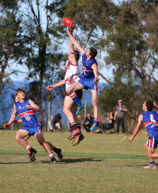 High flyers: Jack Burch goes up in the ruck against Sea Eagle Rick Spink during the major semi-final on Saturday where the Diggers went down narrowly.
