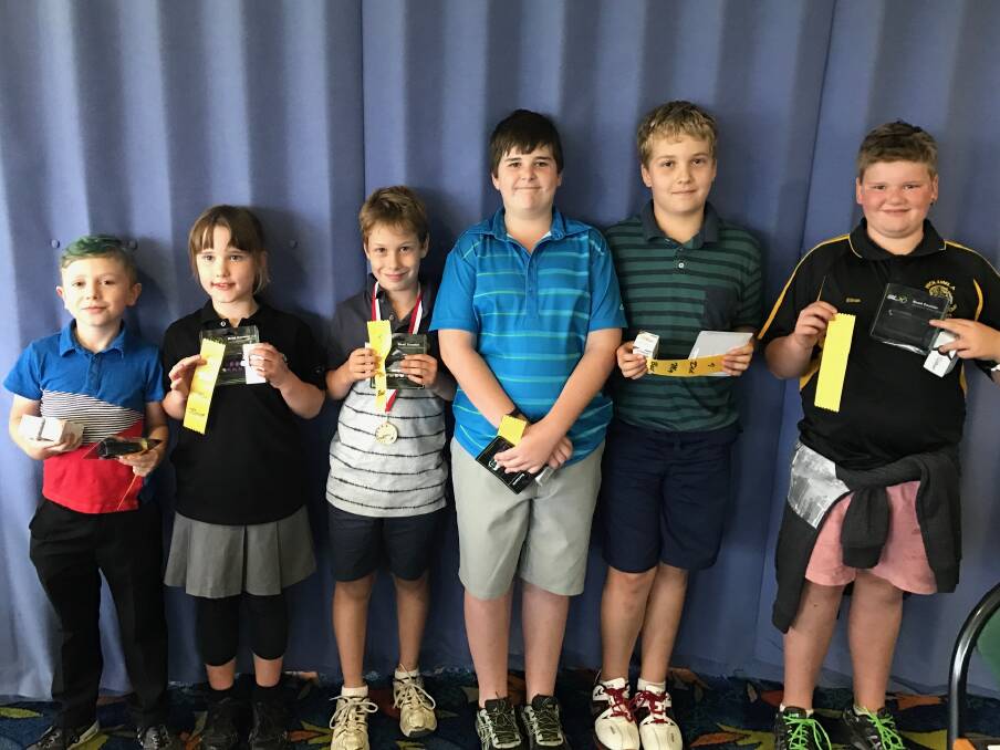 Little tackers: The Tura Beach Junior Open six-hole golfers line up with their prizes after enjoying a great round on the course. 
