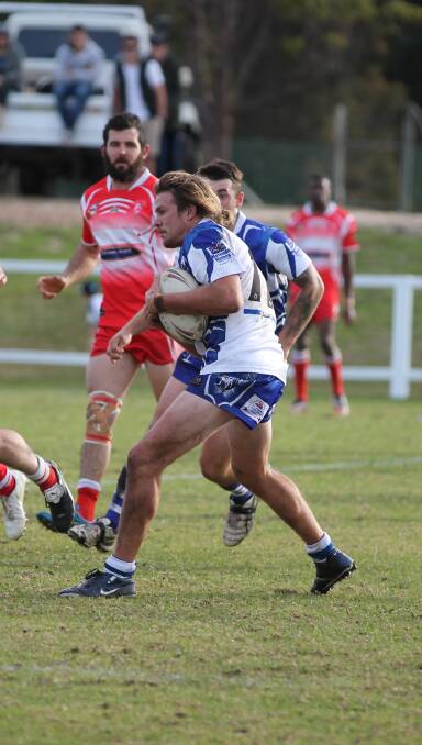 Good metres: Daniel Cronk eyes up his Narooma opponent during Sunday's resounding win for the Bulldogs.