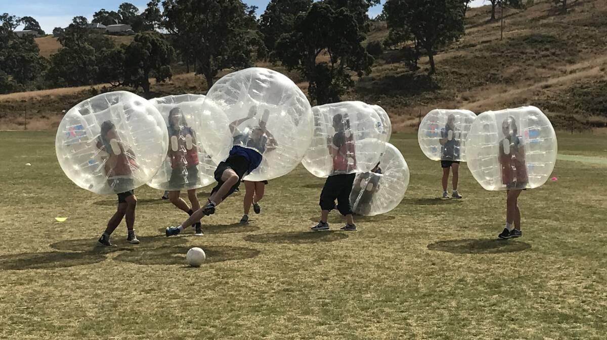 Bouncing around: Sapphire Coast Anglican Students take part in a match of bubble soccer presented by the PCYC recently. Picture: Aimee Hay. 