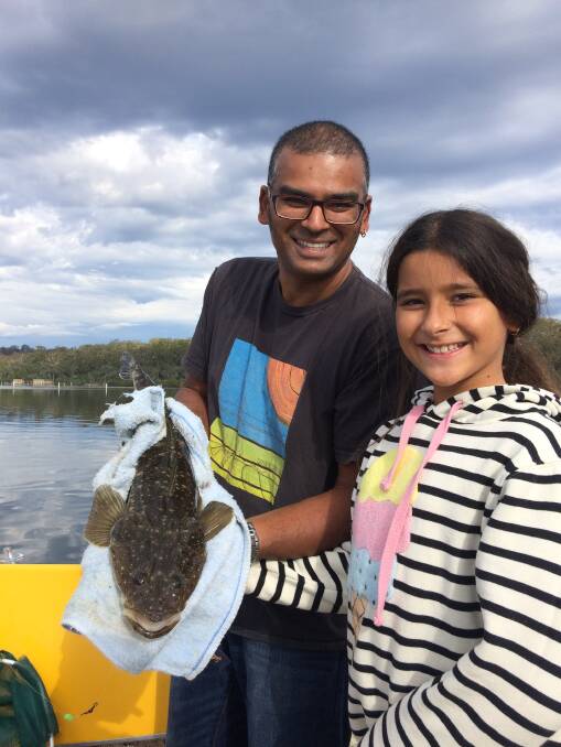 Holiday bonus: Victorian Easter visitor James Armitage and daughter Emily with a beaut catch and release dusky flathead from Merimbula Lake.