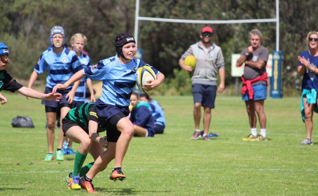On a burst: Lilli O'Dea taking charge at the recent Far South Coast Rugby 7s at Tathra for the Falcons.  Picture: Tom Kiely
