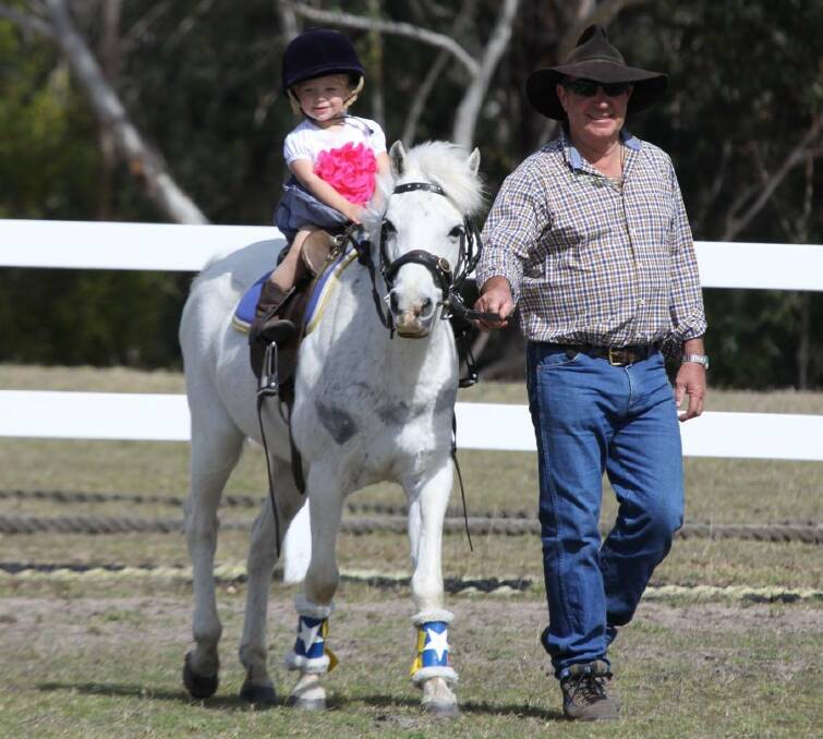 Cute as a button: A Pambula Pony Club young gun is led around the arena at a recent meet with the club encouraging all young riders to join up for fun and friendship. 