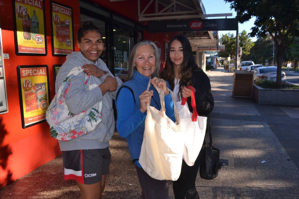 BAG MISSION: Gorgeous Lads & Ladies Against Disposable (GLLAD) Bags founder Mukti hands out some of her free, reusable cloth bags to Nyeasha Hoskins-Moore and Lili Goyma in front of the Narooma IGA. 
