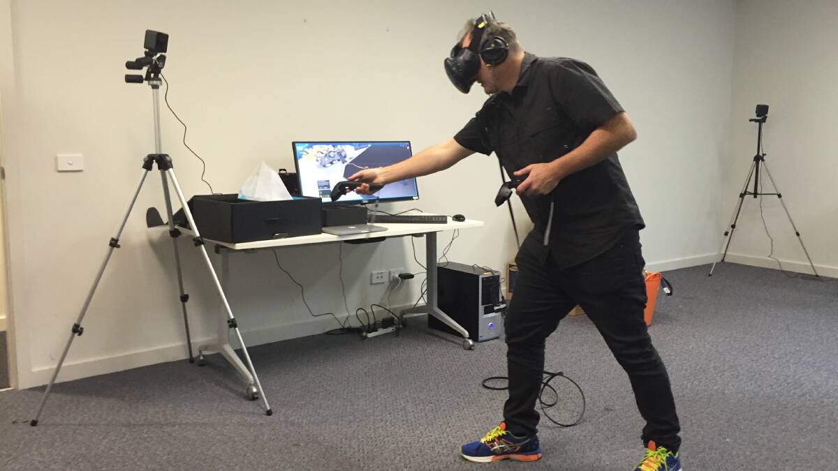 GAME JAM: 2pi Software's Liam O'Duibhir using a virtual reality headset during a Gamer Dev Jam at Merimbula’s Regional Learning Centre in September last year. Picture: Ben Smyth