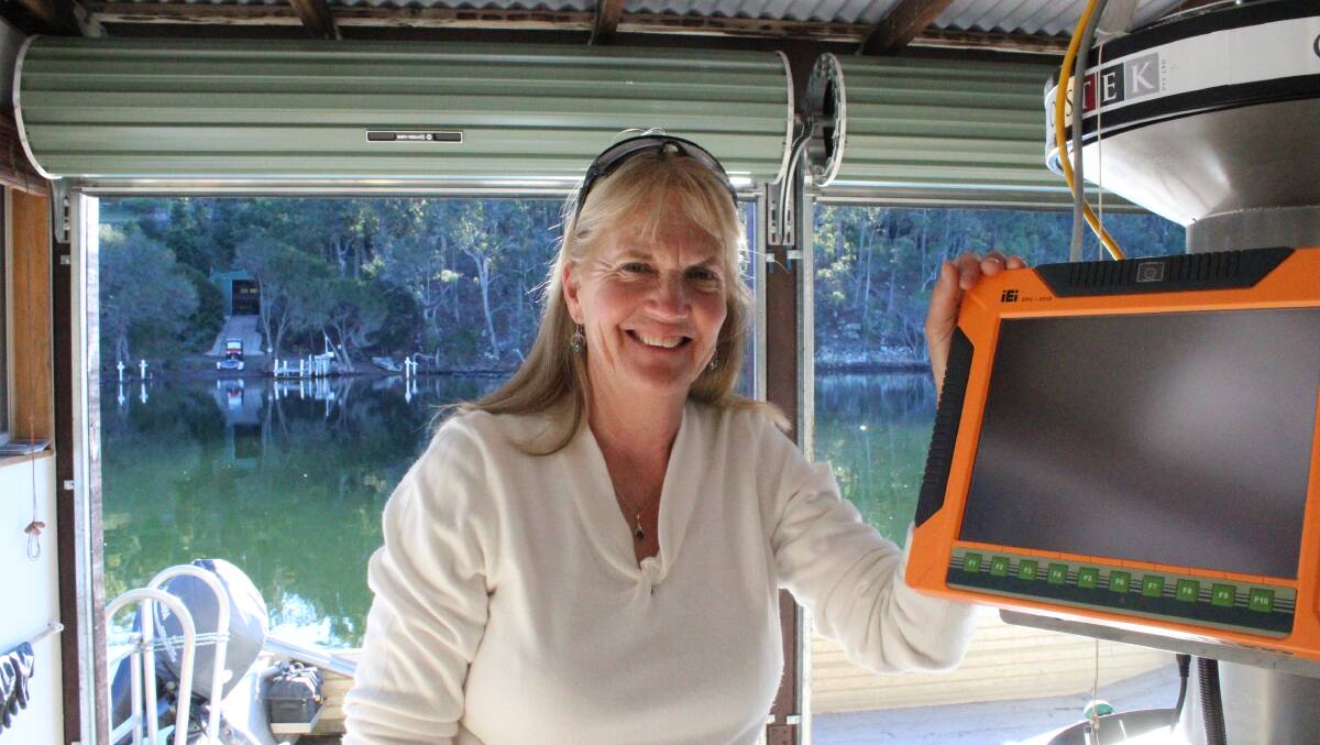 New toy: Caroline Henry with her new oyster grading machine in her shed at Wonboyn Lake. Photo: Zach Hubber