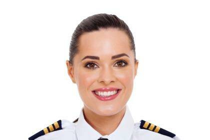 pretty female airline pilot closeup portrait isolated on white Photo: www.delightimages.com
