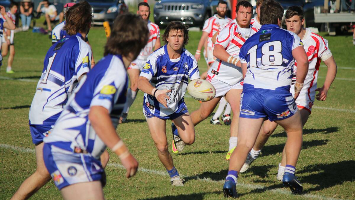 • Aiden Aitken offloads toward the wing during the Merimbula-Pambula Bulldogs loss to the Eden Tigers on Sunday. 