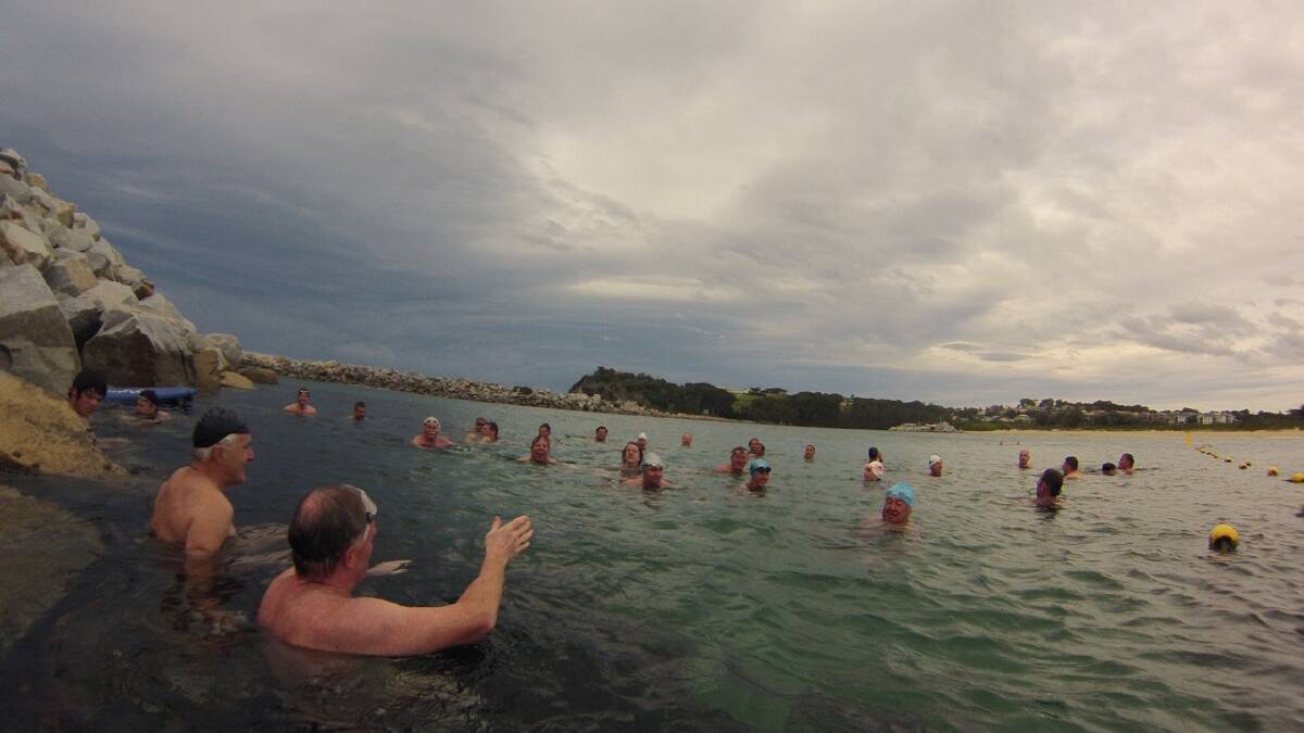 PODGE PREACHES: Mark Rogerson preaching to converted – actually telling his traditional joke at the half-way point of the swim. 