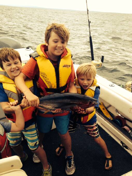 LITTLE YELLOWFIN: Gus Patmore and his little yellowfin caught on Brett McDonald’s boat on Sunday afternoon off Bermagui. (2/4/14) 