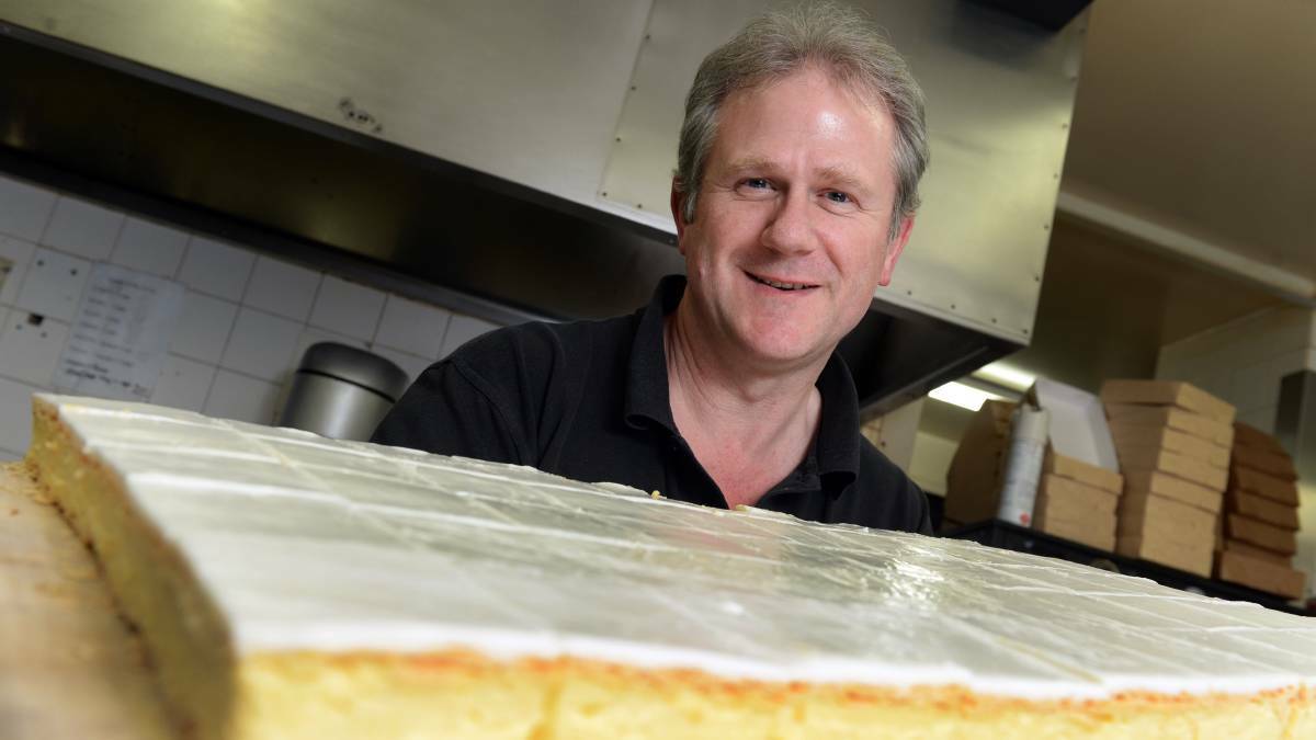 Golden Nugget Bakery owner Colin Matthews tucks into one of the bakery's award-winning vanilla slices. Picture: Kate Healy.