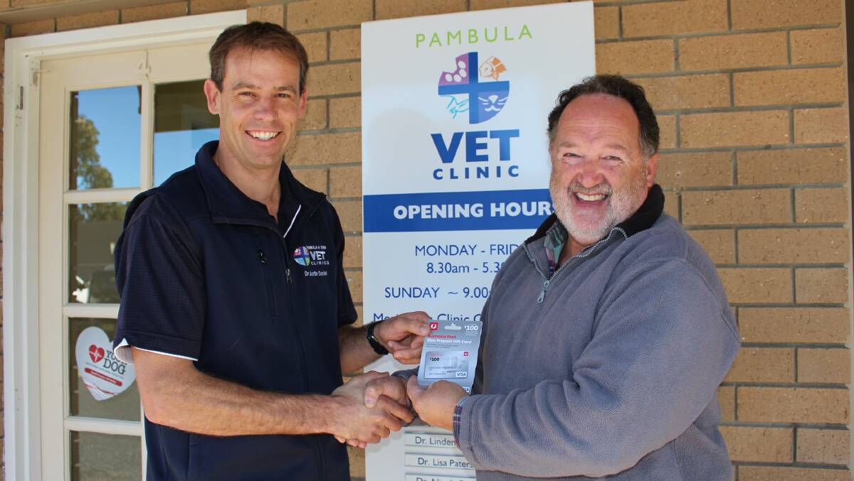 Vet, Dr Justin Daniel, of Pambula and Eden Vet Clinics, left, was quick to come forward with $300 in food vouchers for Sue, which were given to Gavin Bell of the Social Justice Advocates of the Sapphire Coast on Thursday morning. 