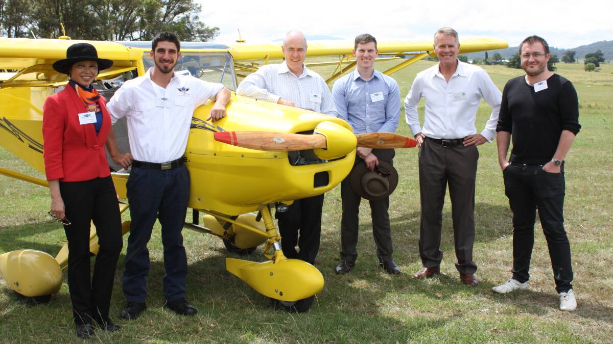 Discussing plans for a Chinese flight school at Frogs Hollow earlier this year, former Deputy Premier Andrew Stoner (second from right) and company directors of Sports Aviation Australia (from left) Caroline Hong, Mitch Boyle, Jason Parker, Jason Ryan and Brad Stebbing.