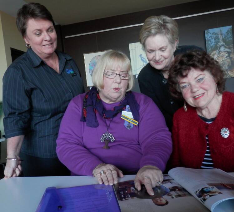 Front: VIEW committee members, Liz Zerbst, left and Joyce McGill, show Club Sapphire events manager Bernita Reardon, left and VIEW club member, Kerry Lewis a photo of Paul West, chef and TV presenter, the July guest speaker for Merimbula Evening VIEW Club.