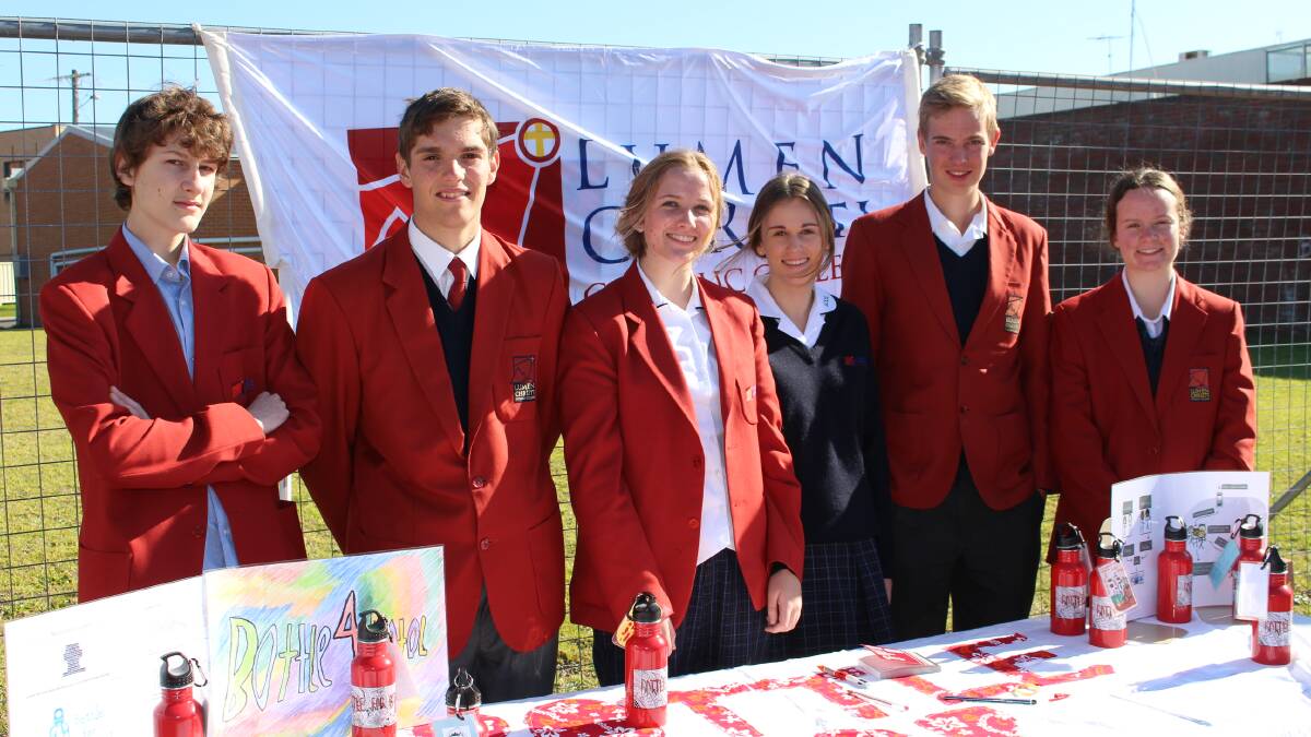 The Year 10 commerce class at Lumen Christi who are selling drink bottles to help students in Indonesia. Lewis Basford, left, Paul Warren, Laura Collins, Sam Routherford, German exchange student Tim Teuberin and Emily Perkins.  
