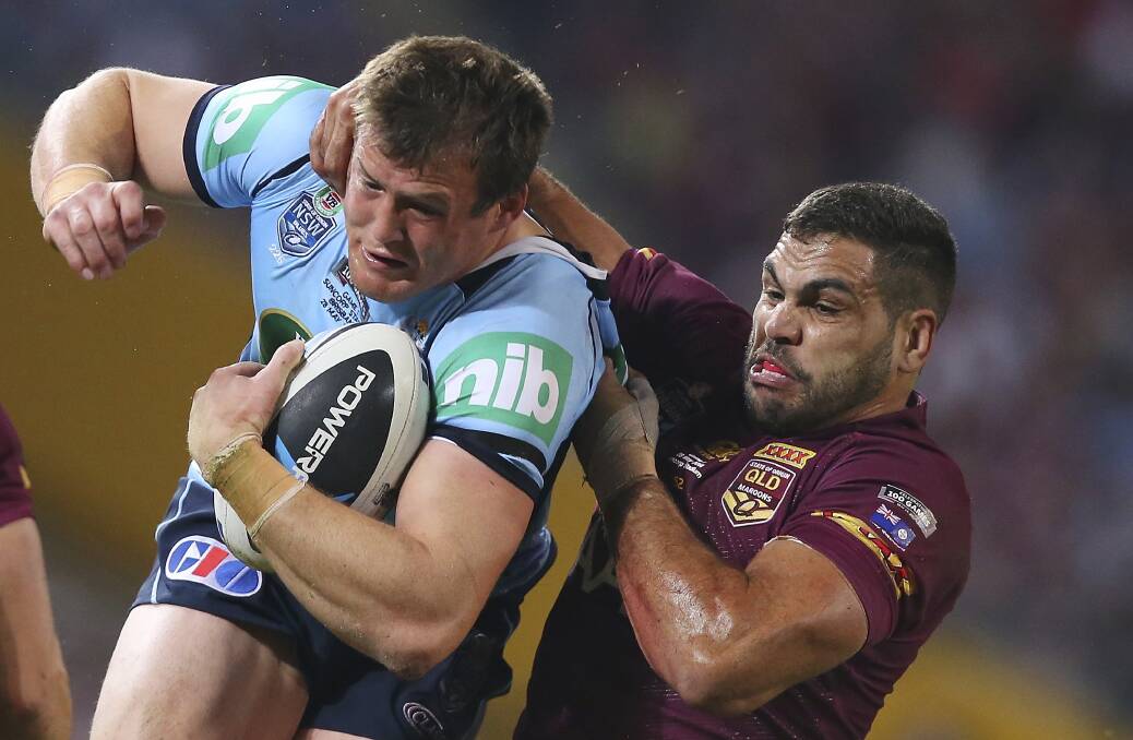 The Blues' Josh Morris is tackled by Greg Inglis of the Maroons in Origin I last year. Photo: Getty Images