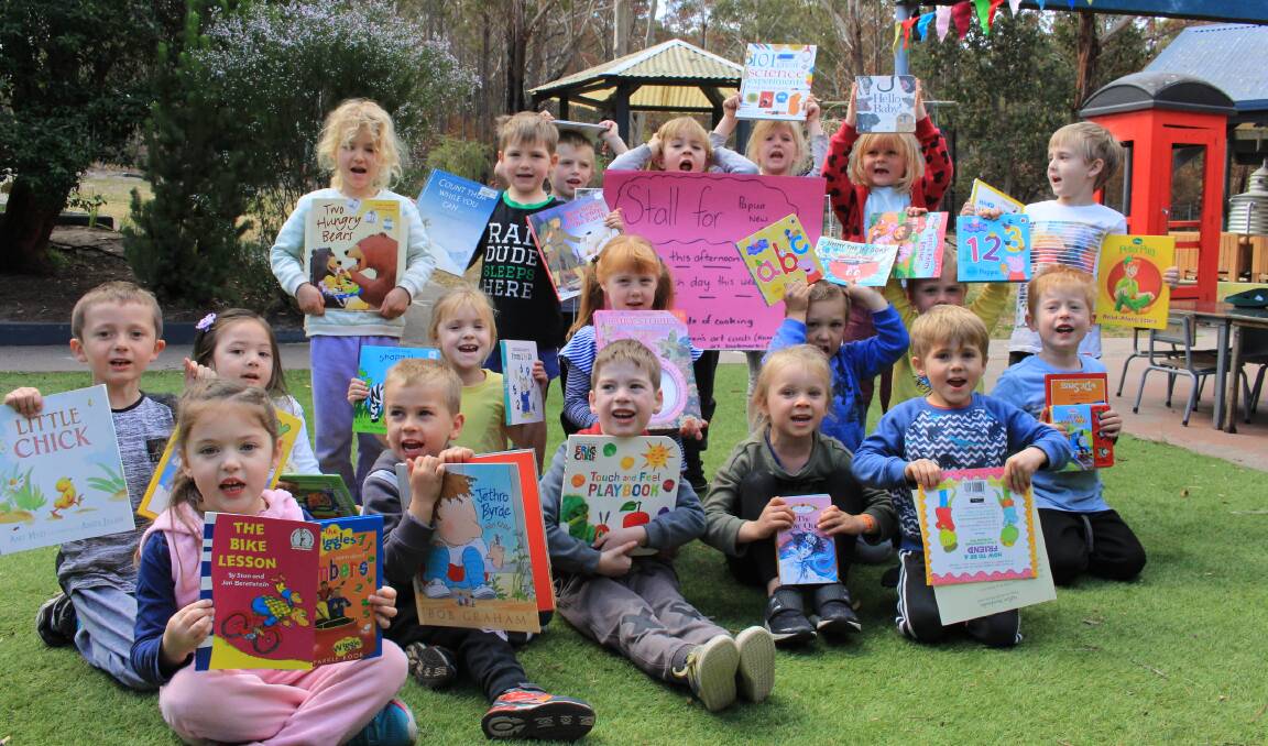 Young philanthropists: Pambula Preschool kids holding up just a small portion of the books they have collected which will be donated to families in Papua New Guinea. Each child is very excited to know they may be giving kids their first ever book.