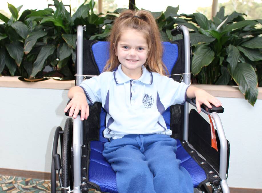 Young and brave: Pambula seven-year-old Emma Peck will be in a wheelchair for at least six months due to an upcoming leg lengthening procedure. Picture: Melanie Leach 