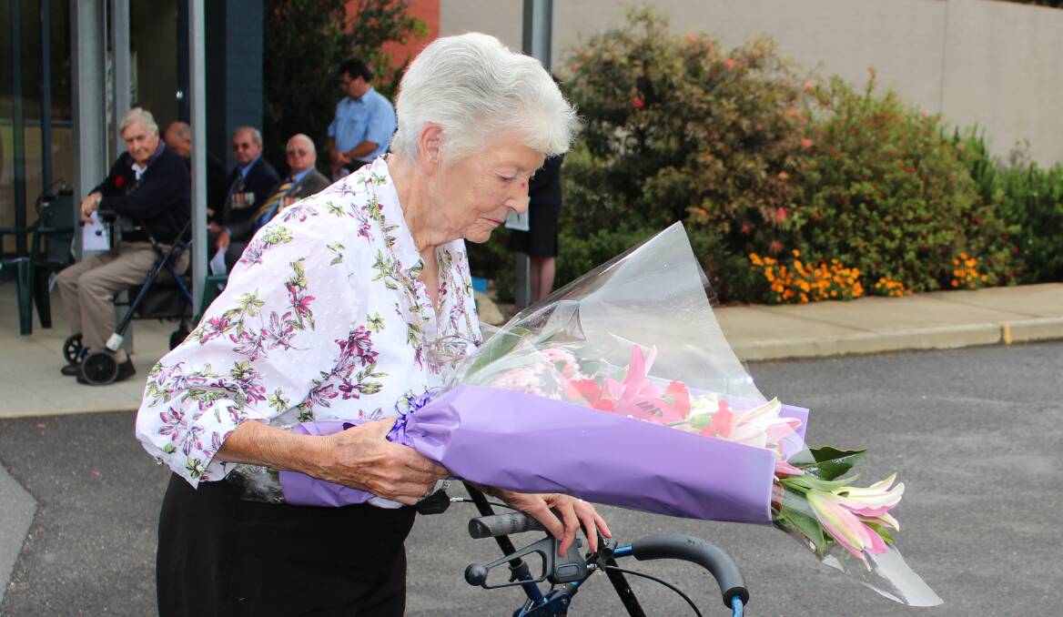 Joan Rival lays a wreath at the Hugh Cunningham Gardens Anzac service on Friday morning. 