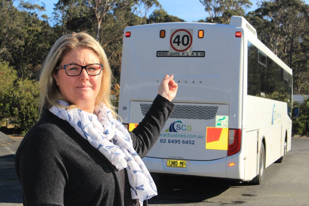 Safety first: Managing director of Sapphire Coast Buslines Jamie Klemm points to the flashing lights on the back of the bus, reminding parents and drivers that the road rules are in place protect children's lives. Picture: Melanie Leach