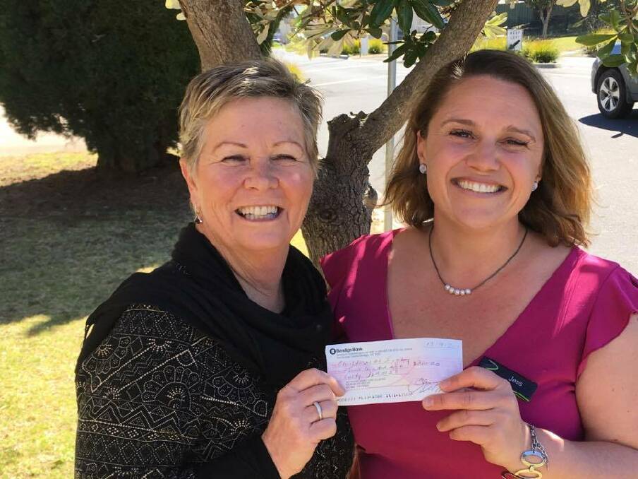 Jess Ryan sponsorship and marketing manager from Sapphire Coast Turf Club hands over a cheque to Eden Chamber of Commerce president Jenny Robb. 
