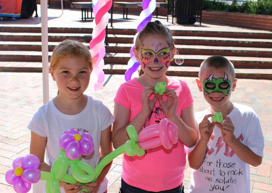 Smiling faces: Khloe Pearse, of Merimbula and Talia and Calab Greenwell of Tura Beach were amazed by the incredible balloon creations at the Spring Madness day. 