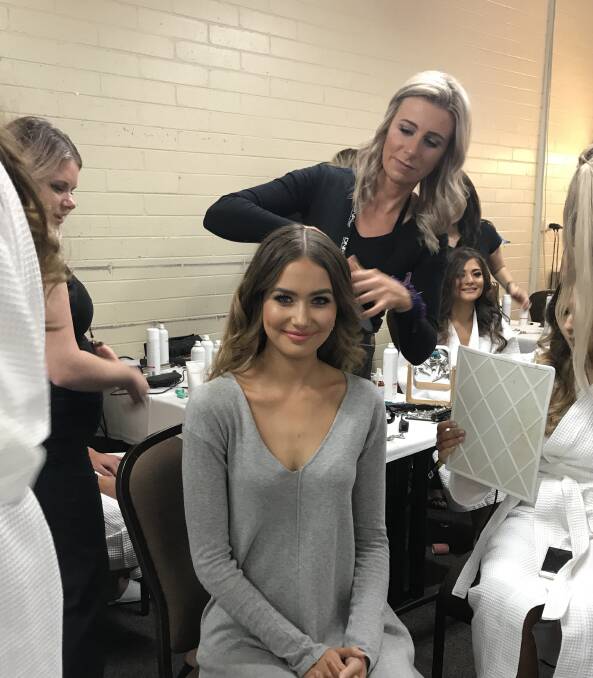 Hair on fleek: Trendsetter Hair Studio owner Rebecca Russell styles the hair of former Miss Universe Australia Caris Tiivel at the competition grand final in Melbourne. 