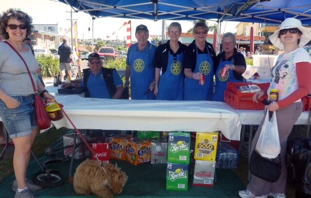 Enjoying last Sunday’s Rotary Merimbula Seaside Market and Fair were Gliki Kyrou, with Simba the dog and Effie Jones, from Melbourne at the Rotary barbecue tent were with Ron Finneran, Cam Edgerton, Kim Loveday, Gai Byrne and Miriam Edgerton.