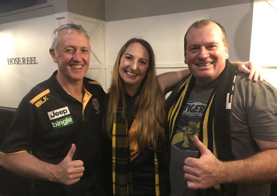 Yellow and Black: Merimbula locals Anthony Daly, Melanie Leach and Paul Pincini were shocked to run into each other at a bar in Melbourne last Saturday where they were all celebrating the Tigers making it to the big dance.